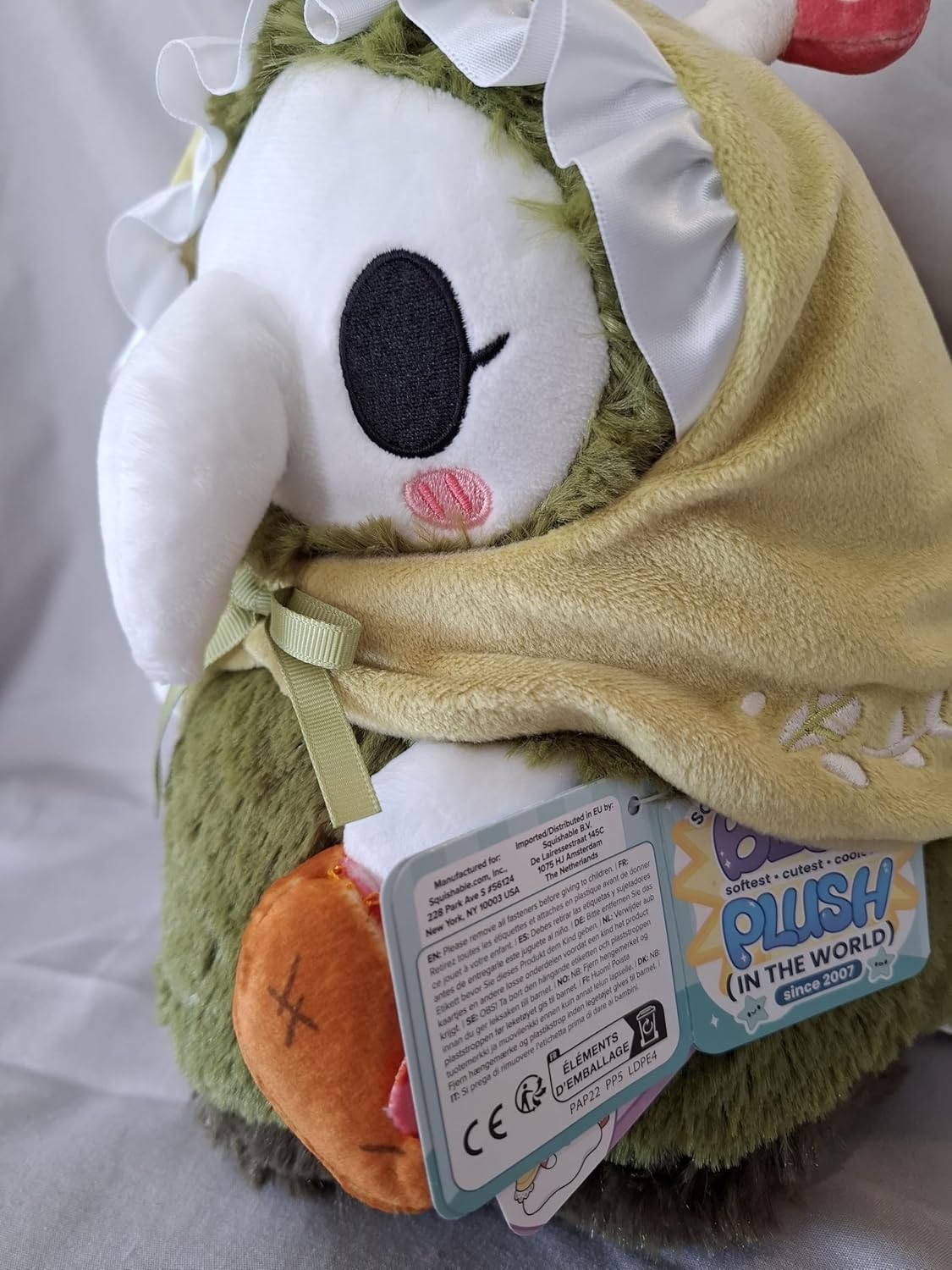 Squishable Woodland Nurse resting on a bed demonstrates a huggable plush for reading nook.
