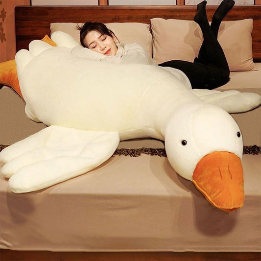 Srutirbo giant white goose plush on bed, a cozy cuddle companion