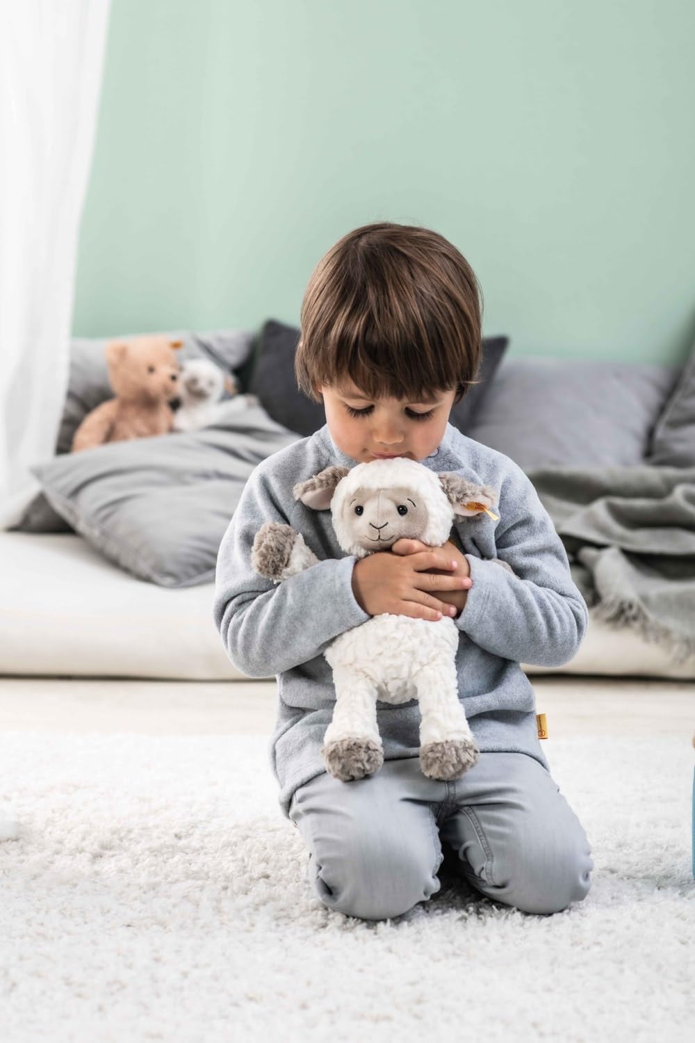 Steiff Lita Lamb with glossy safety eyes for secure, kid-friendly features.
