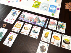 Stonemaier Tokaido meals and landscapes, savoring unique experiences.