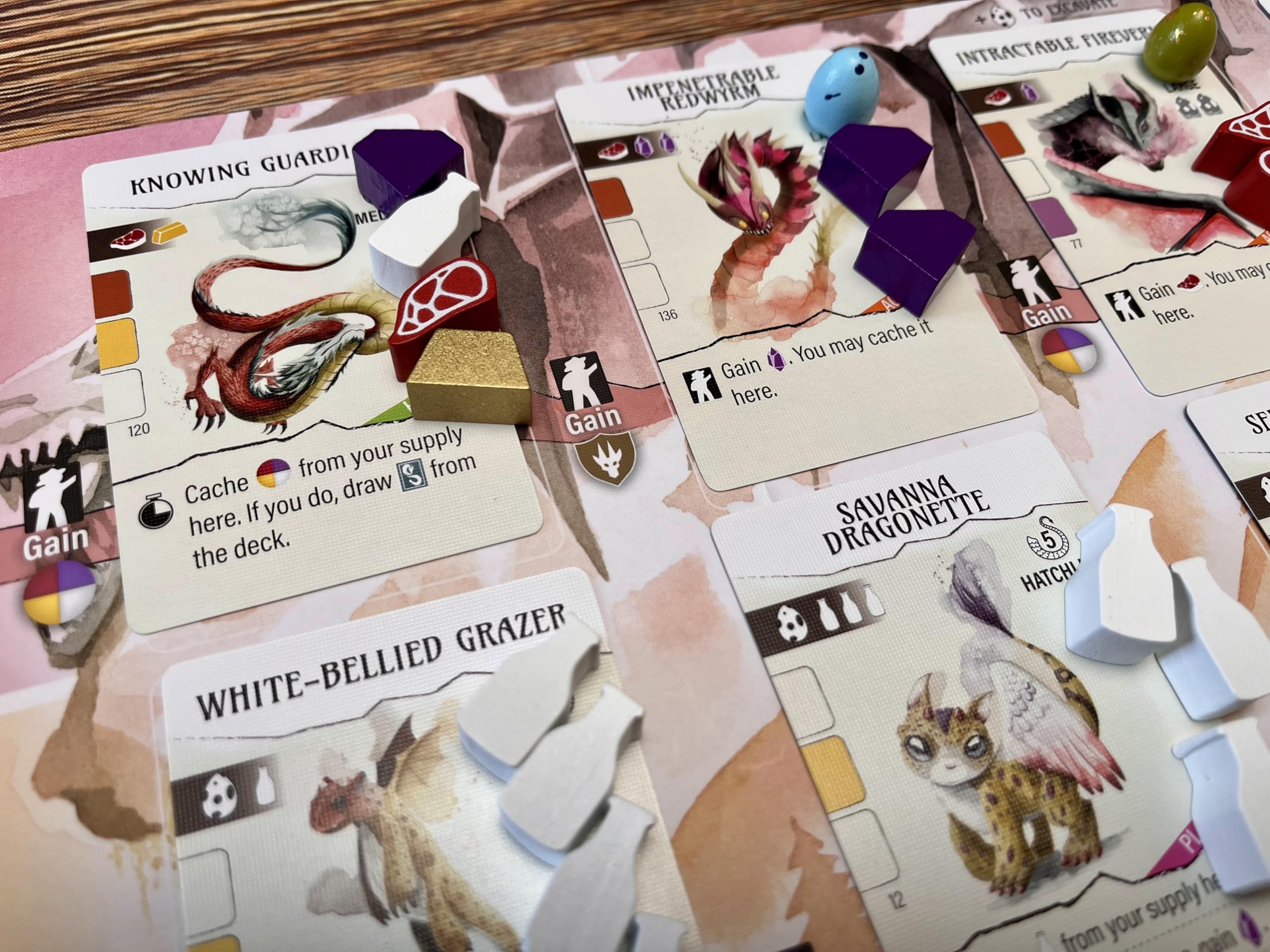 Stonemaier Wyrmspan resources on table showcase vibrant components