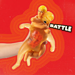 STRETCH ARMSTRONG beside a ruler showing the 10-inch scale for size clarity
