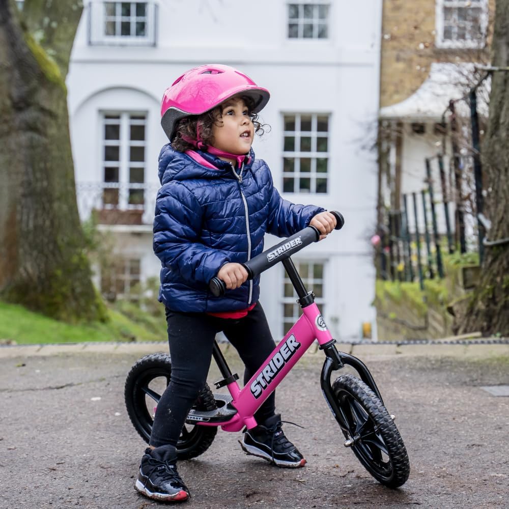 Strider 12” Sport Bike pink seat offers comfortable support for kids.