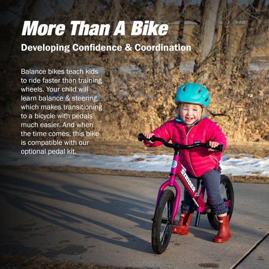 Strider 14x balance bike side view with Funky Fuschia finish shows adjustable fit for growing riders