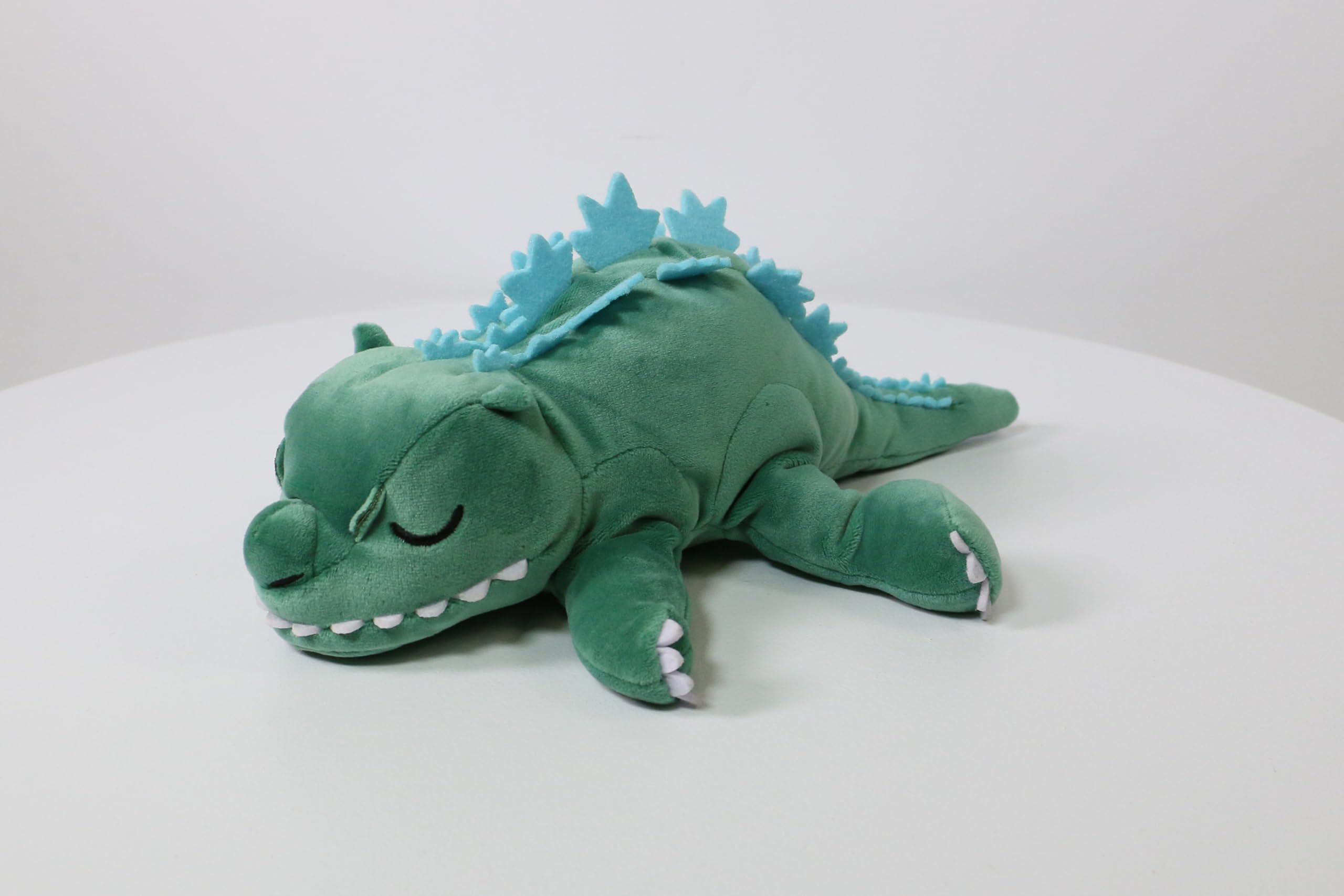 Surreal Entertainment Godzilla plush back view highlighting tail and body proportions.