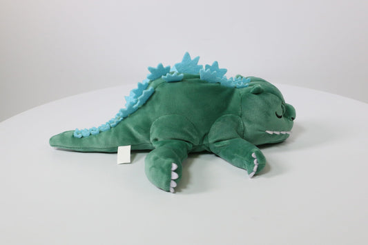 Surreal Entertainment Godzilla plush sleeping expression highlights cozy bedtime companion.