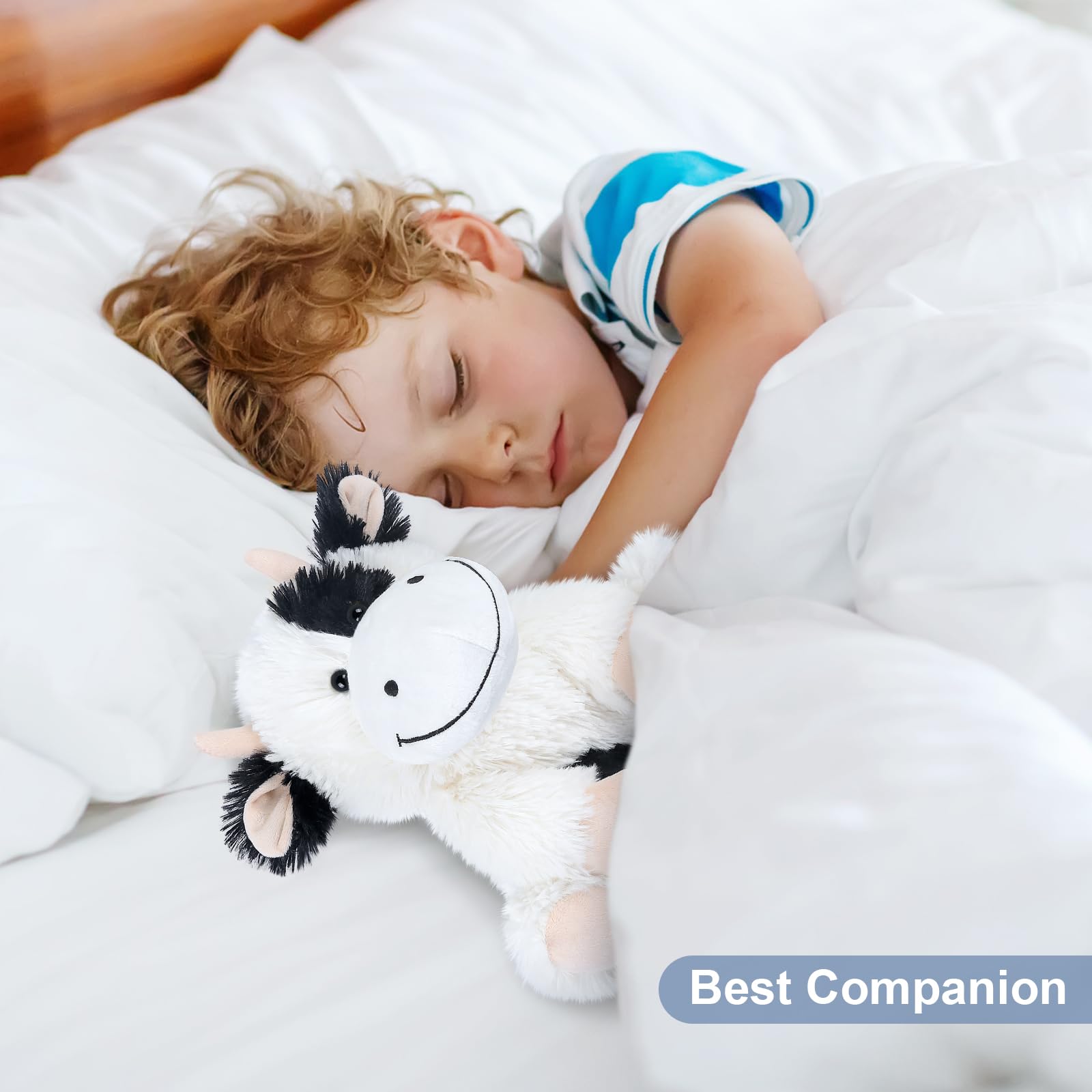 SuzziPals cow plush in bedtime snuggle setup for cozy nights