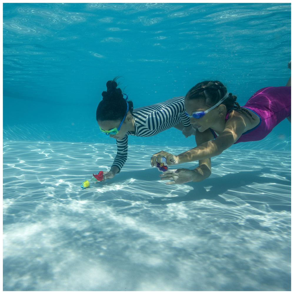 Children enjoying SwimWays Little Mermaid dive characters during pool time