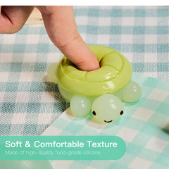 Tabasquishy Turtle held in hand demonstrates portable desk accessory for stress relief.