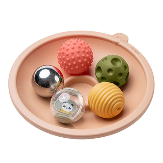 Taf Toys tummy time play tray with rounded base shows gentle sway to support exploration.