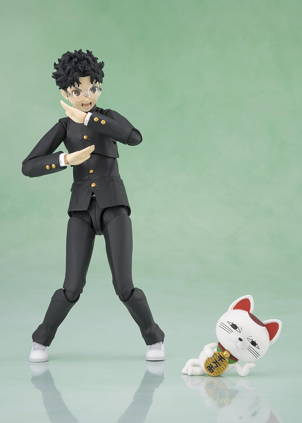 Turbo Baba beckoning cat accessory adds playful charm to Okarun.