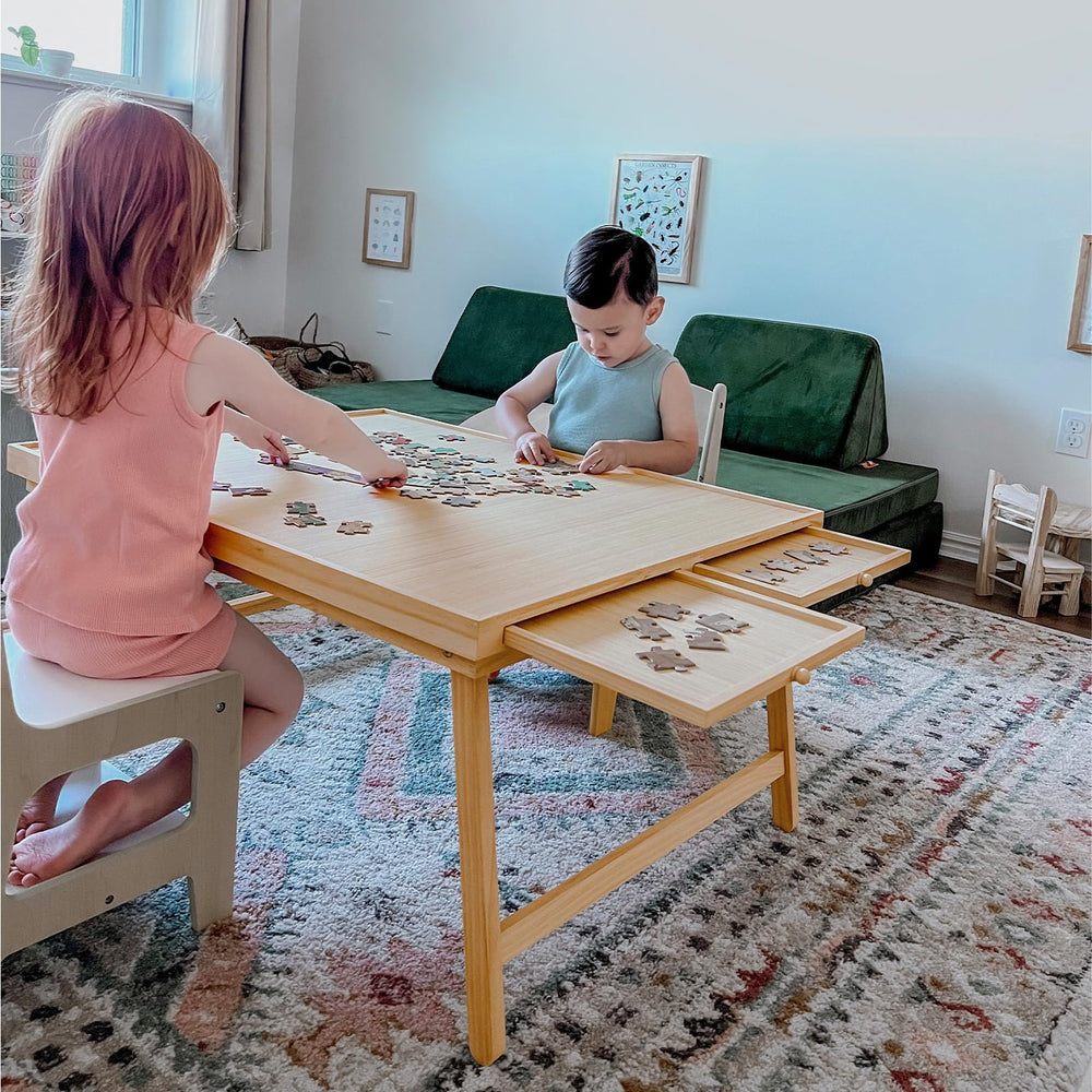 TEAKMAMA puzzle table with 4 drawers keeps pieces organized during play.