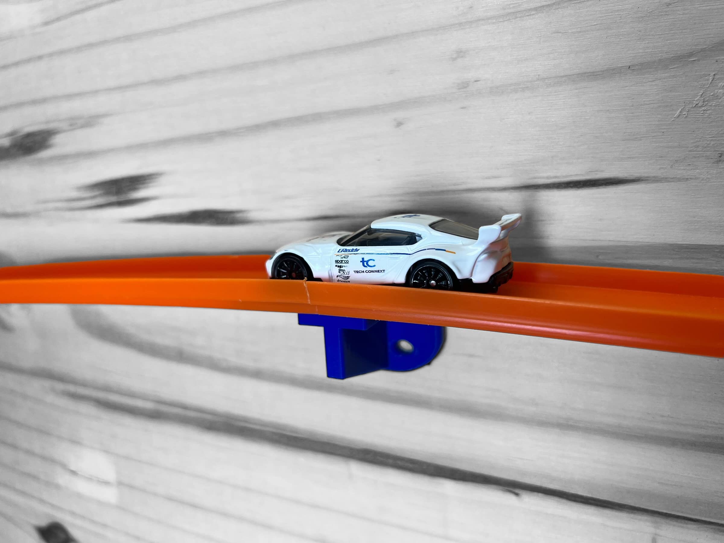 TechConnext 4-Pack blue wall mount demonstrates secure grip for 1/64 scale cars.