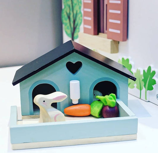 Tender Leaf Toys guinea pig hutch with water bottle supports pretend caregiving.