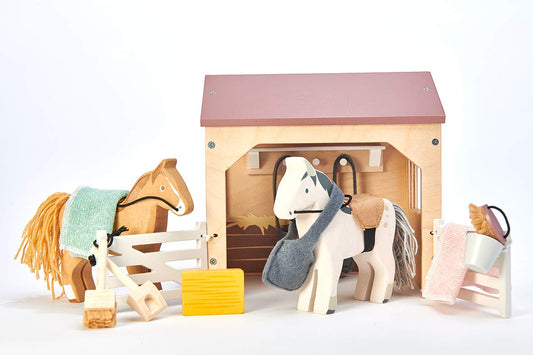 Tender Leaf Toys The Stables showing hay bale and saddles for role play