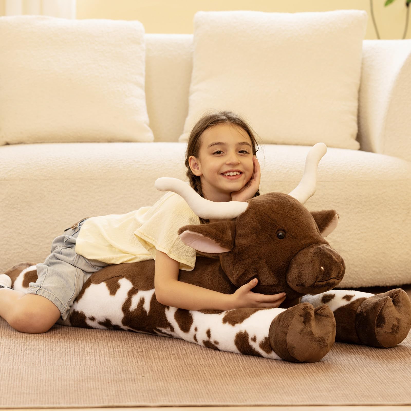 Tezituor jumbo cow plush on sofa adds decorative charm and warmth