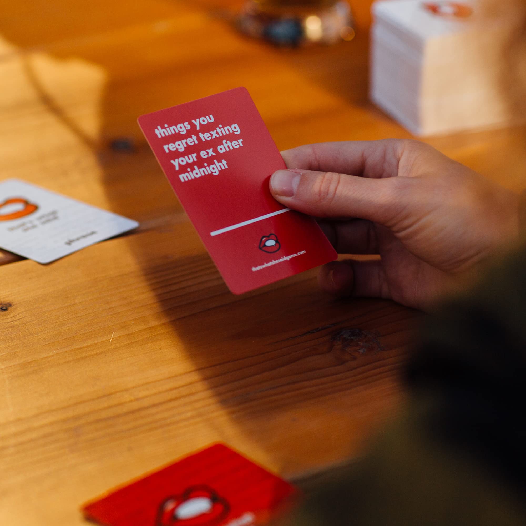 White phrase cards from That's What She Said offer varied prompts for laughs