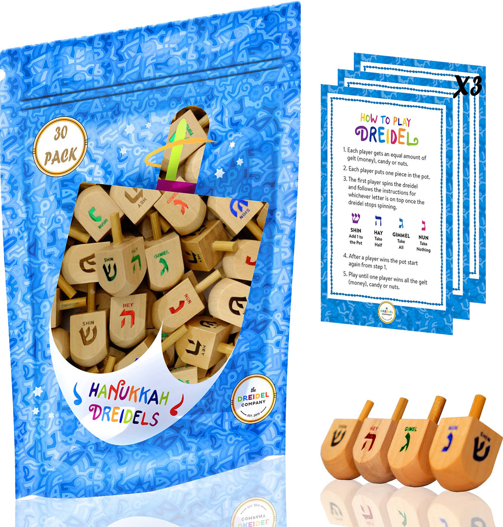 The Dreidel Company 25-pack natural wood dreidels ready for Hanukkah play.