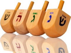 Kids enjoy spinning the wooden dreidel during family game night