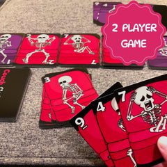 The Dusty Tophat Couch Skeletons cards with numbers guiding fast play.