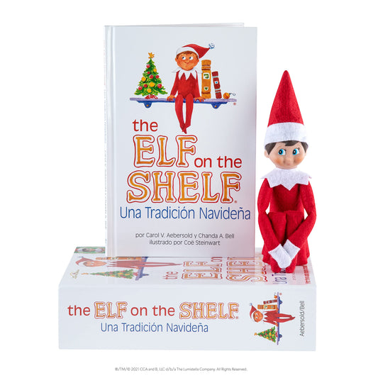 Blue-eyed scout elf beside The Elf on the Shelf book.