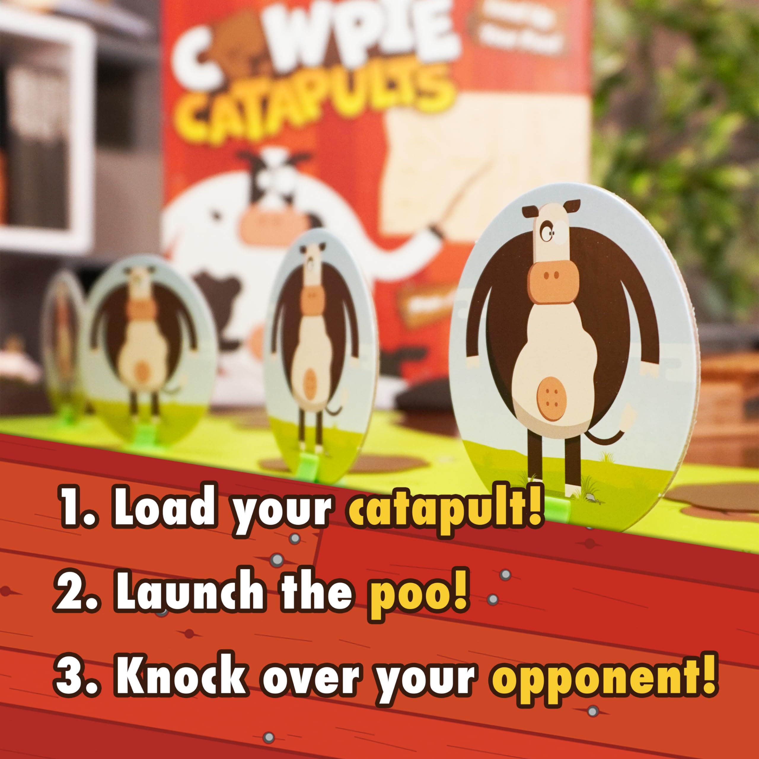 The Good Game Company action: players launch cowpies for tense catapult duel.