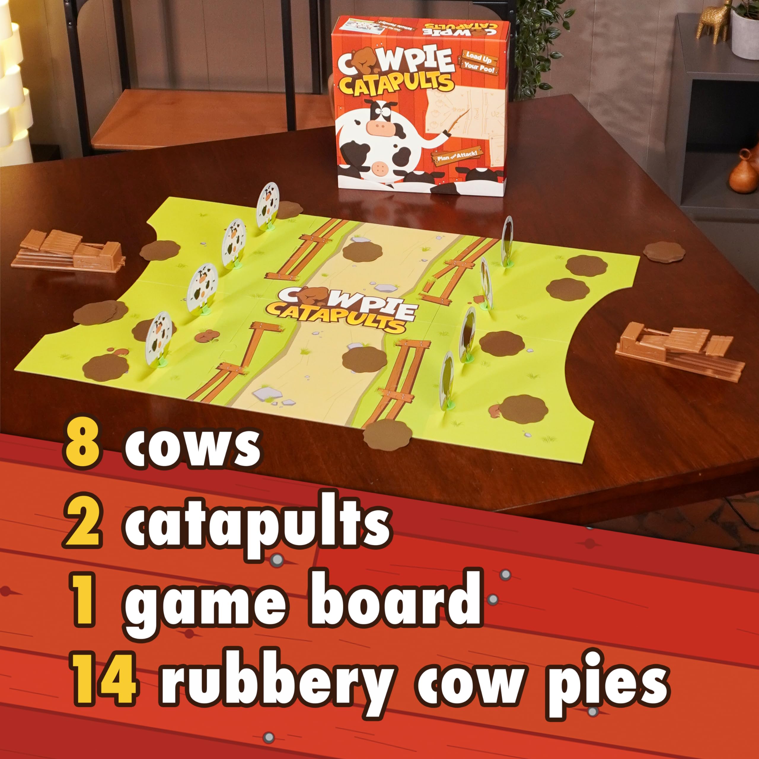 The Good Game Company Cowpie Catapults game board showing cows ready to topple.