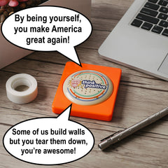 The Monocle Breakers Trump button in action on a desk prompts 15 quotes.
