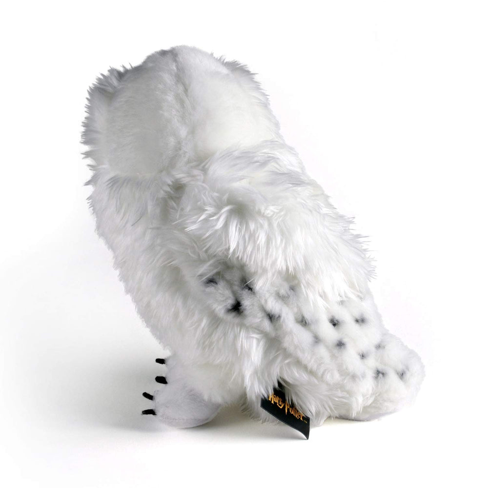 The Noble Collection Hedwig plush with official logo tag, authentic merchandise.