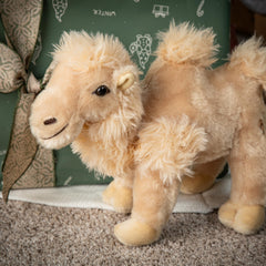 The Petting Zoo Bactrian camel plush smiling face invites cozy hugs during storytime.