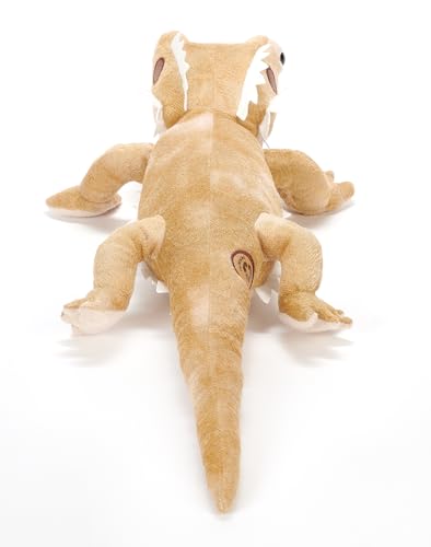 The Petting Zoo Bearded Dragon plush on a bed, bedtime companion for gentle nights.