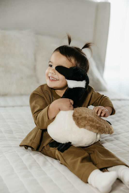 The Petting Zoo goose plush shows a long black beak for lifelike play.