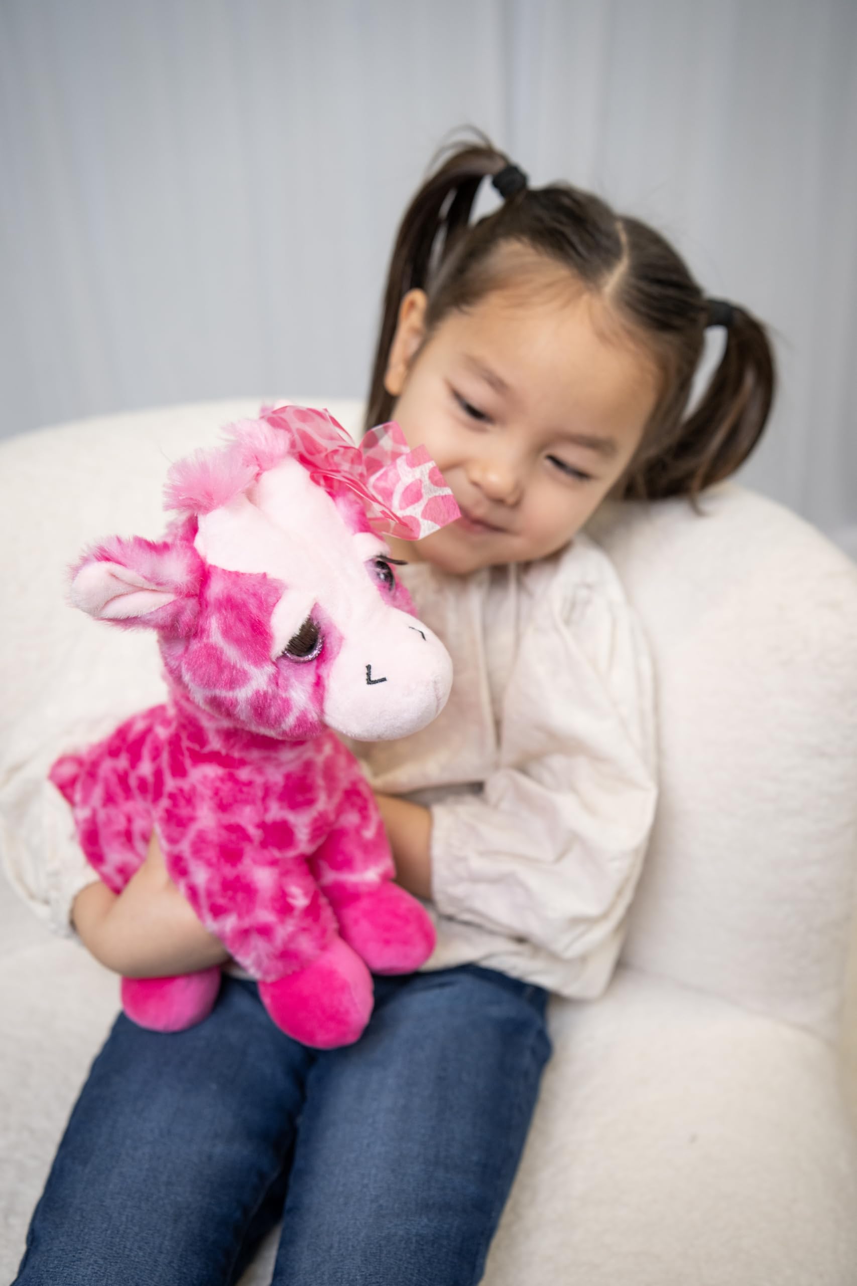 The Petting Zoo pink giraffe plush with lashes invites cuddly adventures.
