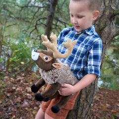 The Petting Zoo reindeer plush shown as a gift-ready item on a shelf.
