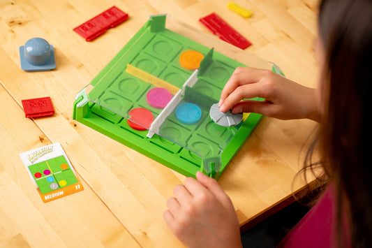 ThinkFun Invasion of the Cow Snatchers magnetic tokens engage fine motor skills during placement.