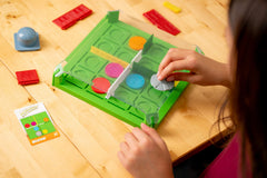 ThinkFun Invasion of the Cow Snatchers magnetic tokens engage fine motor skills during placement.