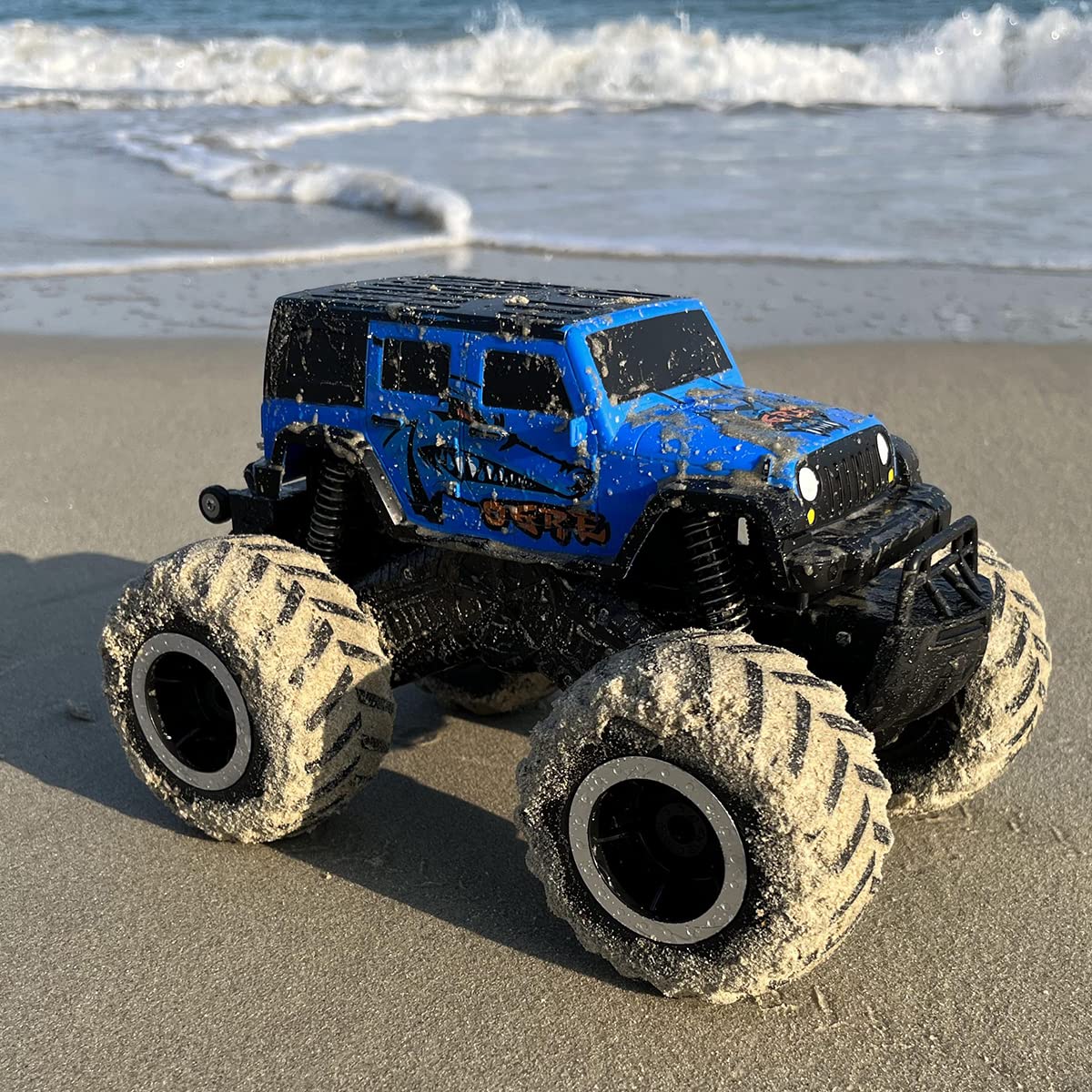 Threeking 1:16 monster truck racing across grass and sand