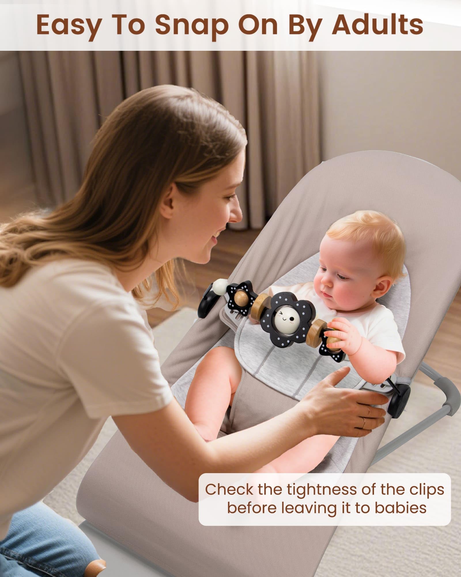 TinlyFinly toy bar in use with babies watching and interacting with black and white flowers