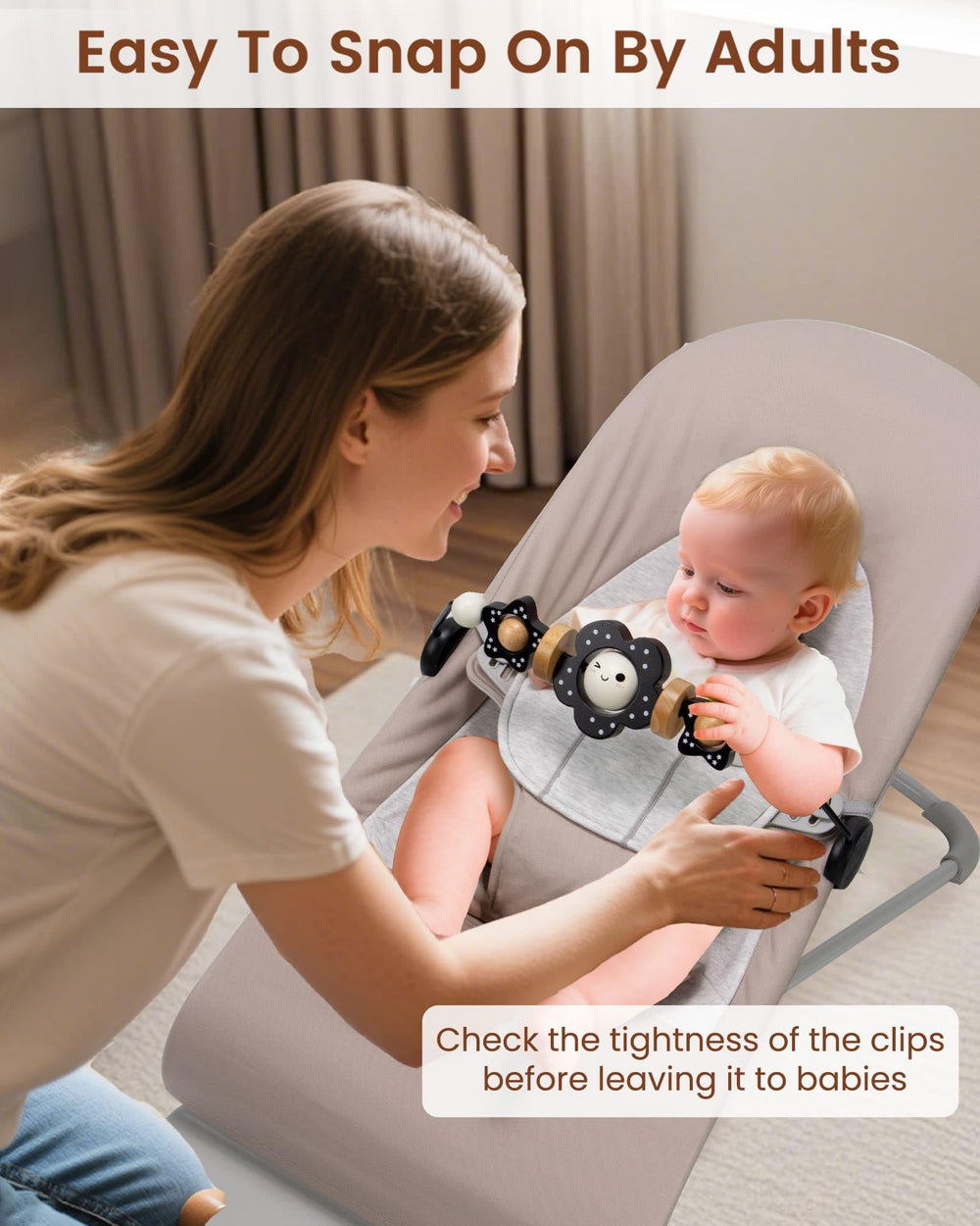 TinlyFinly toy bar in use with babies watching and interacting with black and white flowers