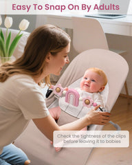 Baby watching and touching TinlyFinly toy bar while it spins