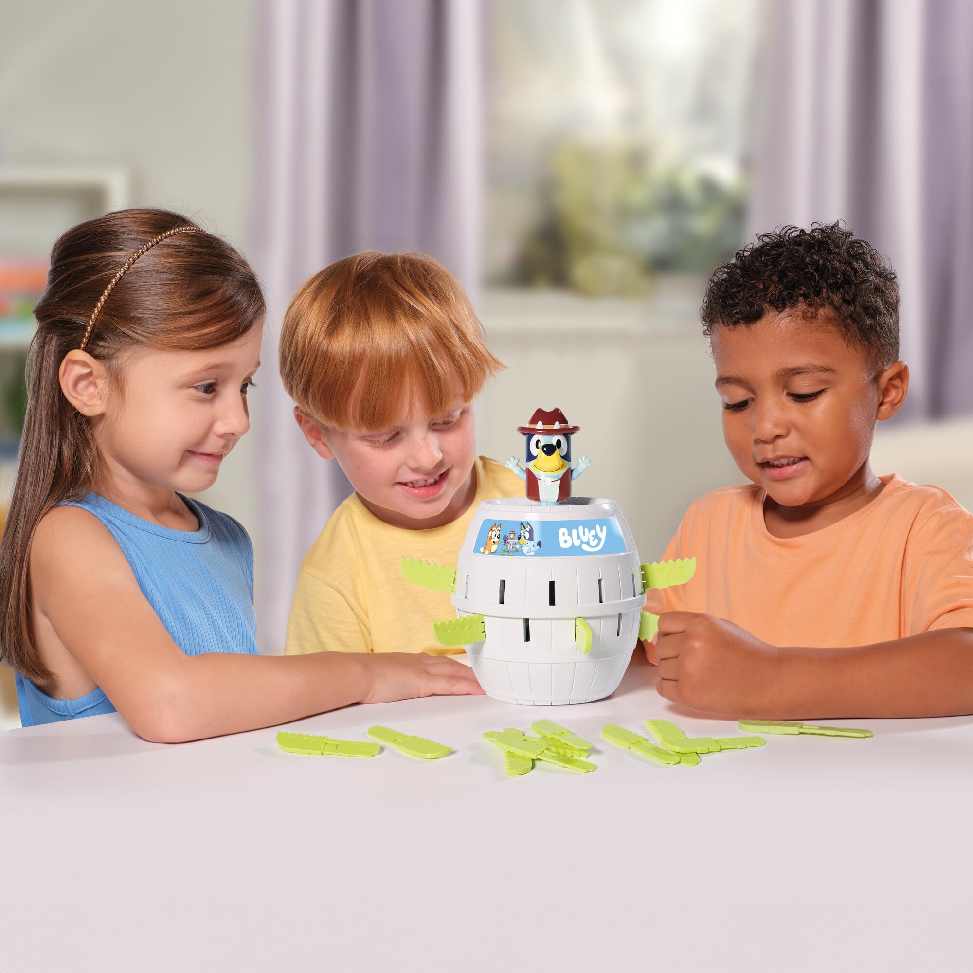 Family plays TOMY Pop Up Bluey for a cozy game night.