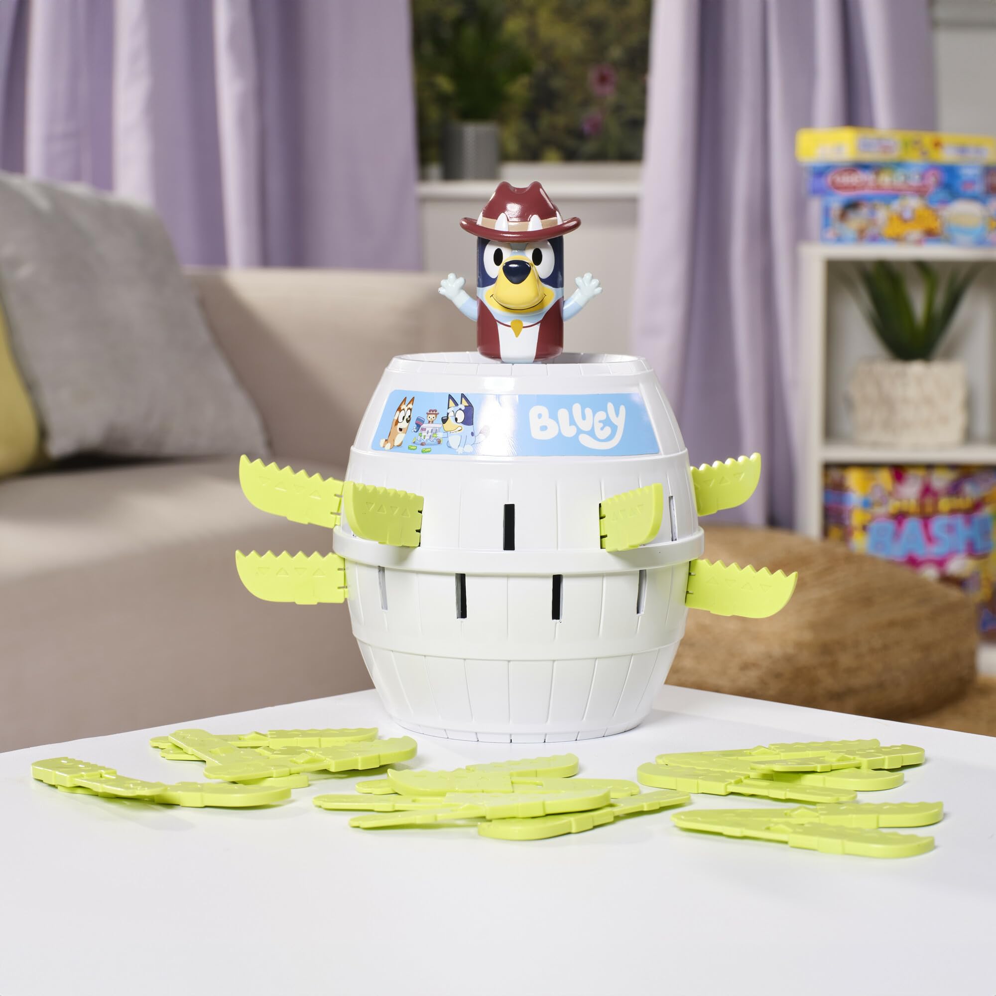 TOMY Pop Up Bluey game in action as Bluey pops from the barrel.