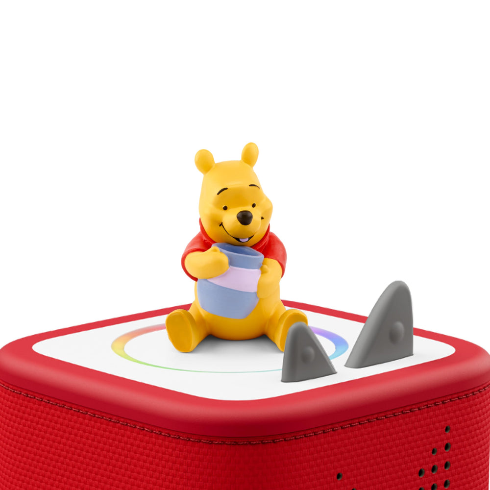 Winnie the Pooh figure beside a Toniebox for easy listening