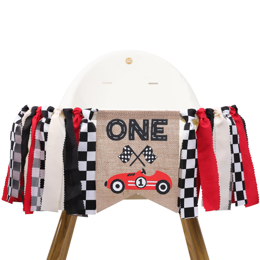 TUTOTU Race Car One high chair banner attached to the chair for a festive first birthday.