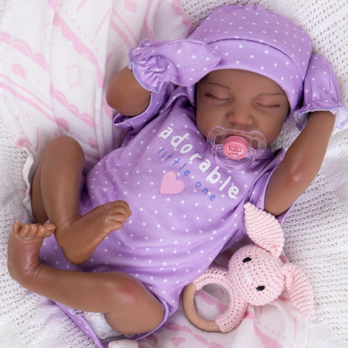 UOFTKIZ black reborn doll with mottled skin for lifelike newborn play and nurturing bonding.