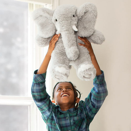 Gray elephant plush side view showing soft fur and friendly expression.