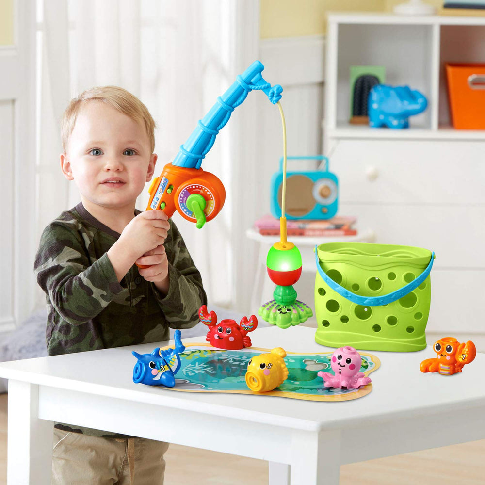 Interactive fishing pole guiding a magnetic catch above the mat