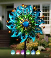 VUFOZ solar wind spinner with peacock-feather blades in turquoise glow for outdoor decor.