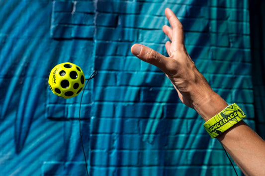 Waboba Bounceback Returning Moon closeup yellow ball, showcasing vivid texture and bounce.