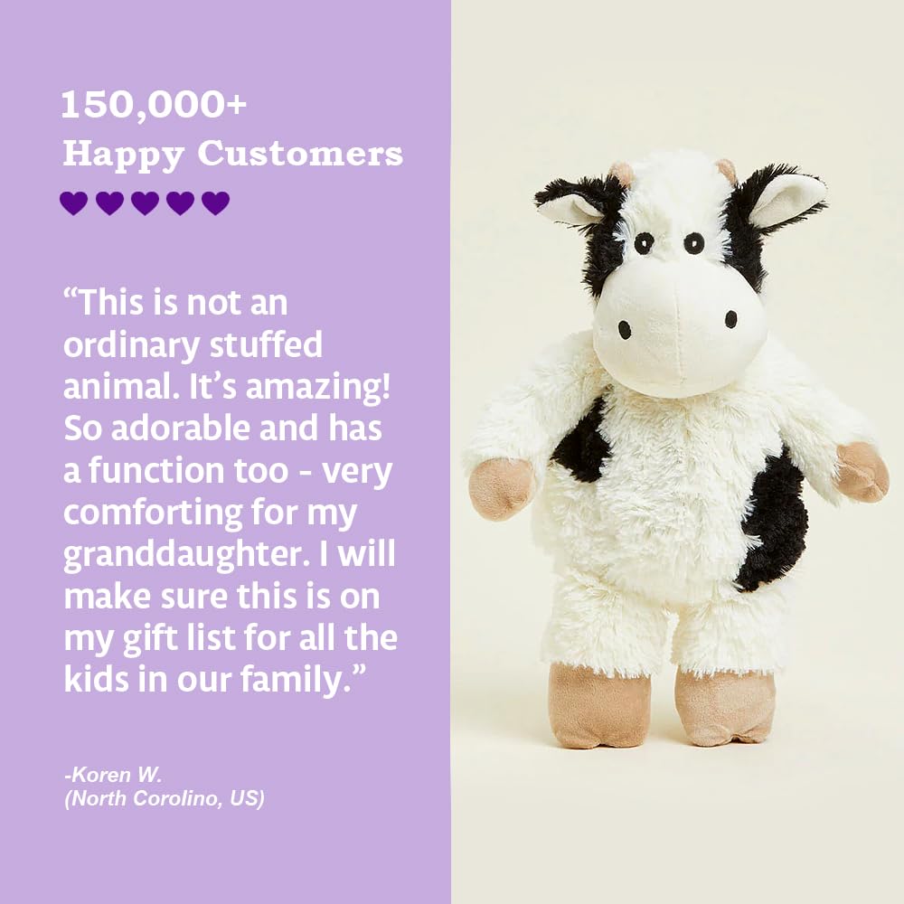 Warmies Junior Cow Plush held for bedtime snuggling